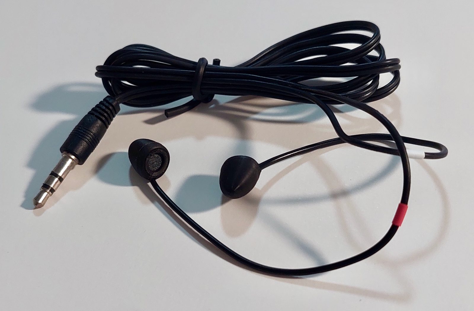 A pair of EarEqual Plugs with the TRS cable, showing the embedded measurement microphone